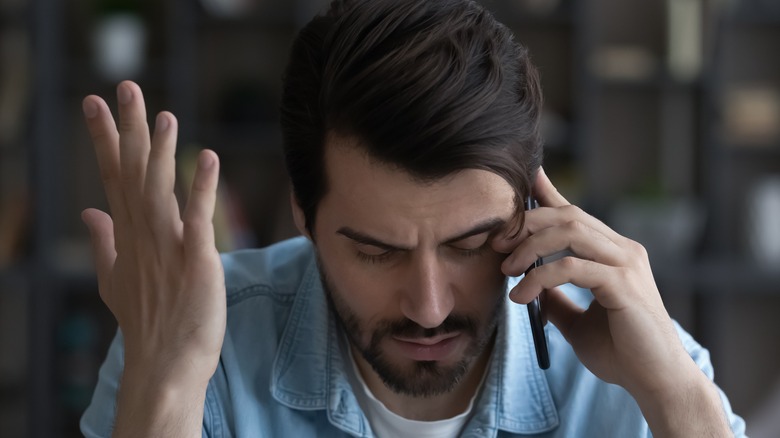 stressed man on phone