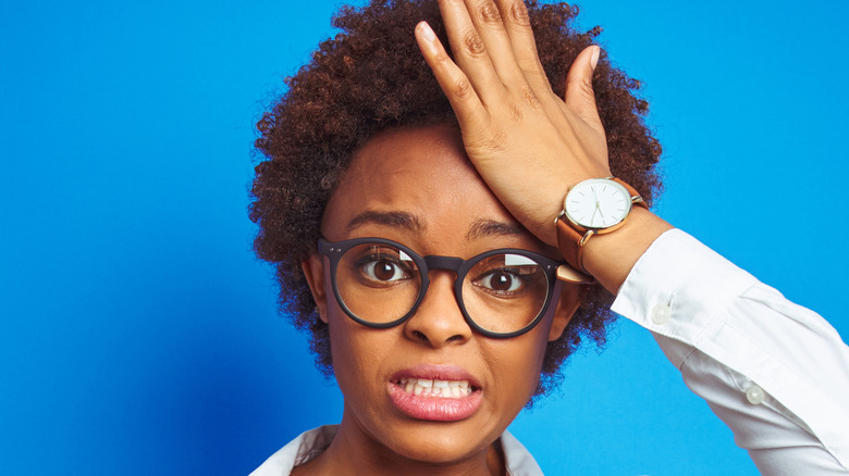 tired woman holding head