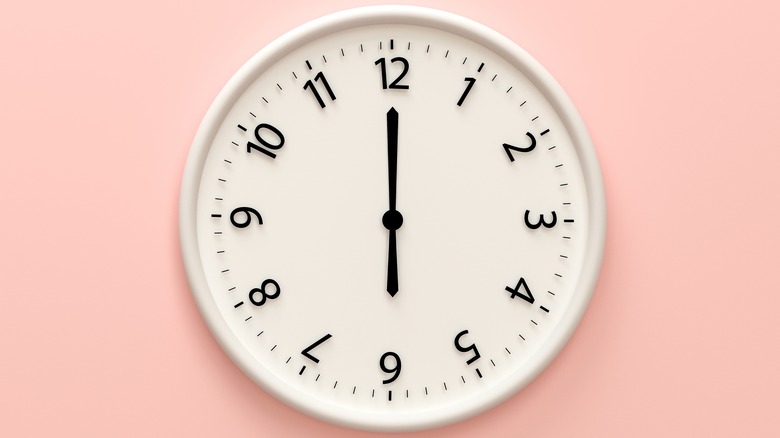 white clock on pink wall