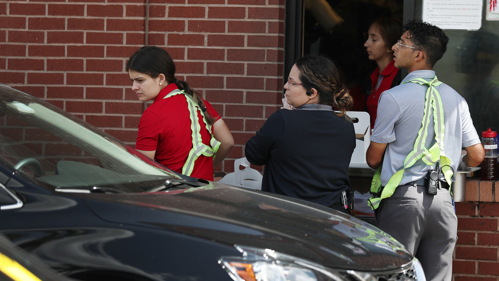 Chick-fil-A workers deliver orders to cars