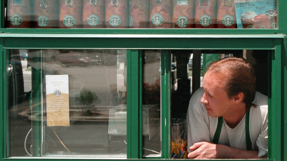 man leaning out of Starbucks drive-thru window