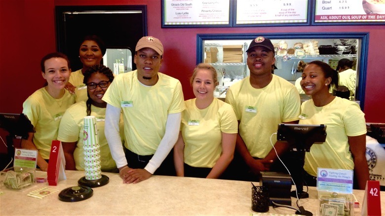 Employees smiling front counter