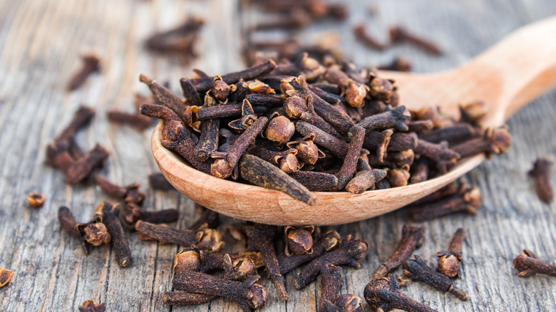 Whole cloves on wooden table