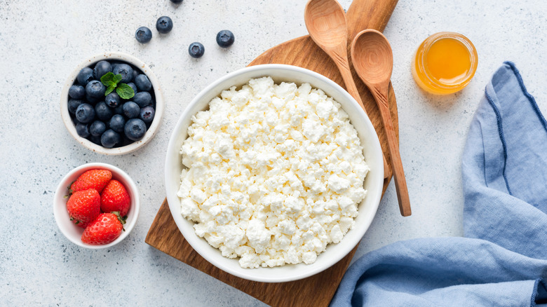 Cottage cheese next to bowls of fruit