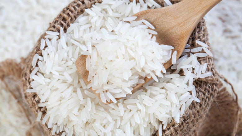 A rice sack with a wooden spoon of rice