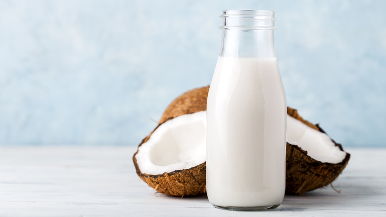 A bottle of milk with coconuts