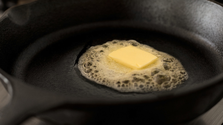 butter melting in cast iron pan
