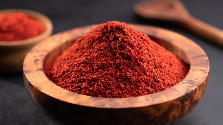 Ground cayenne pepper in wooden bowl