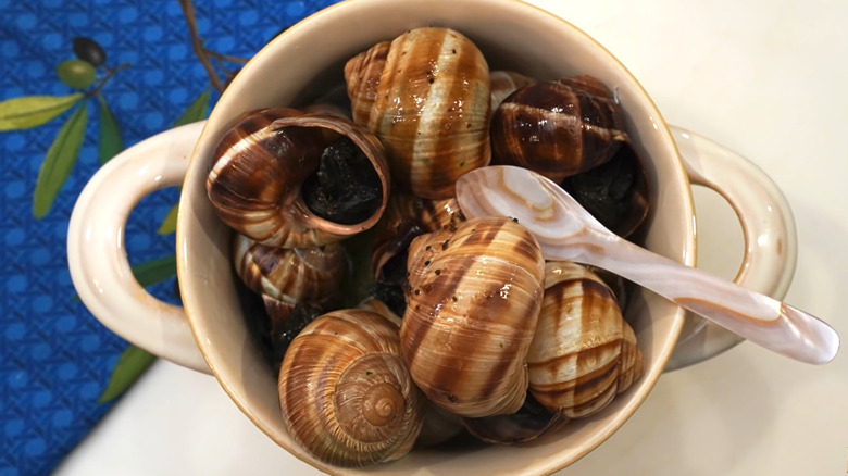 A bowl of cooked snails in shell