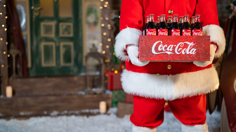 Santa holding a case of Coke