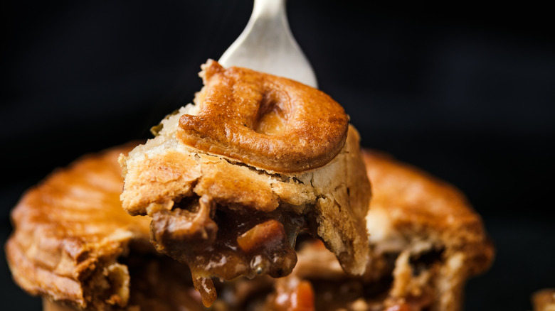 Forkful of duck pie with pastry 