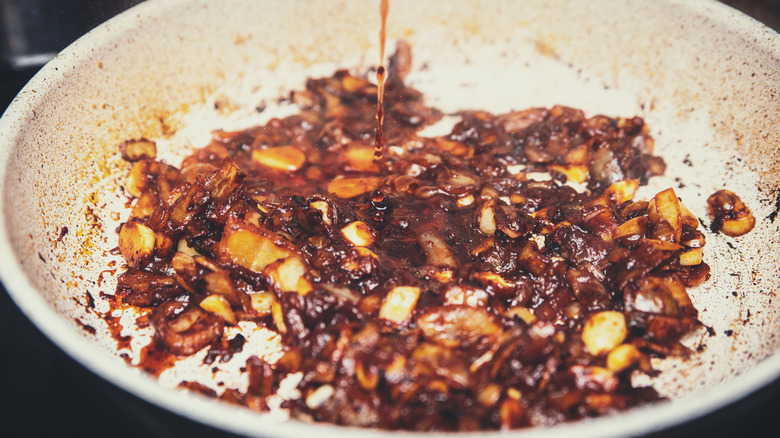 Alcohol pour to deglaze pan with vegetables