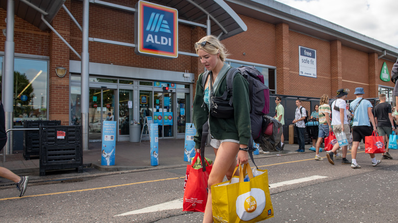 Woman carrying Aldi bags