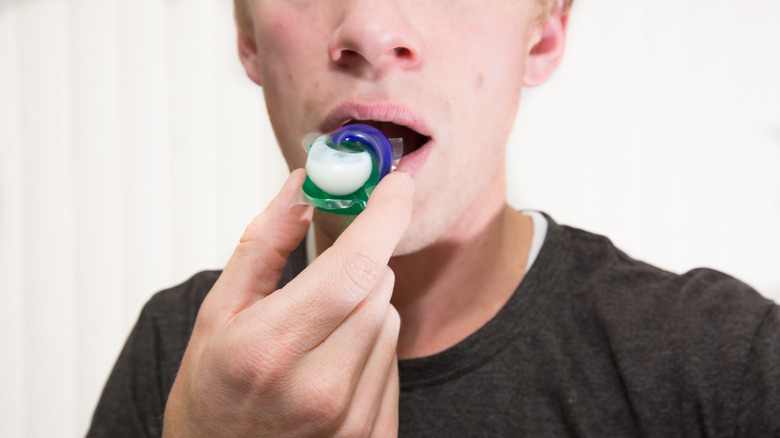 A teen about to bite into Tide Pod 