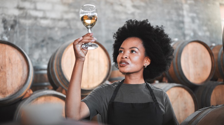 woman tasting wine in winery