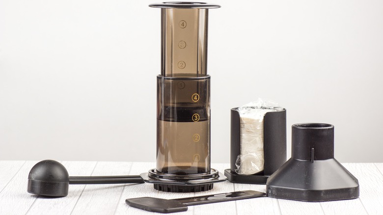 Disassembled AeroPress on white table