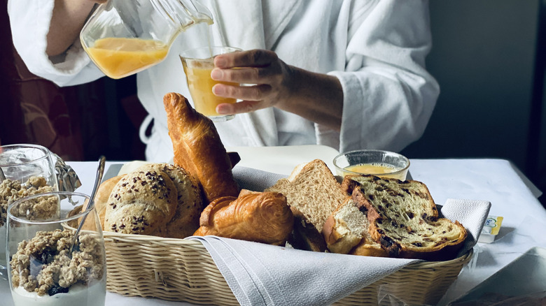 worker preparing breakfast delivery hotel room