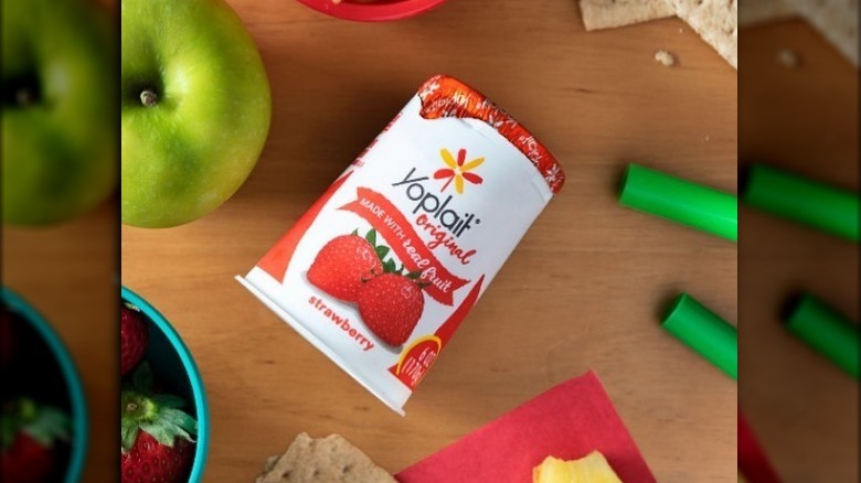 Yoplait Strawberry Yogurt on Table Surrounded by Fruit