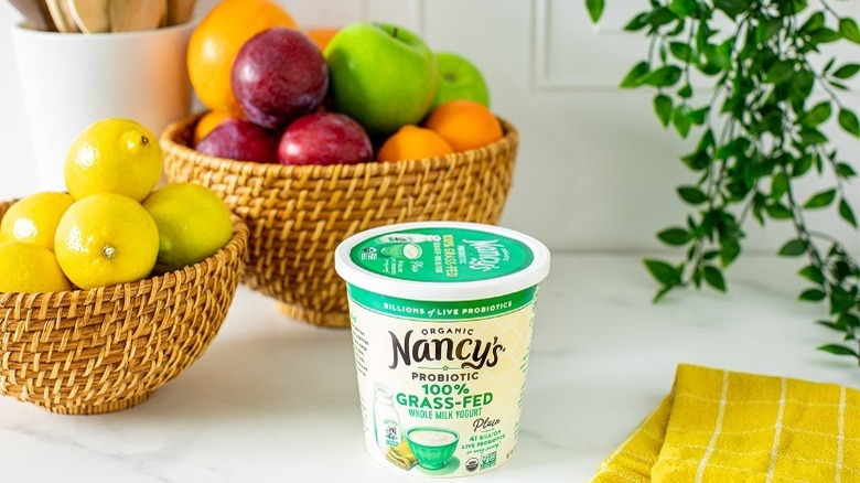 Nancy's Probiotic Yogurt on Counter With Fruit Bowl