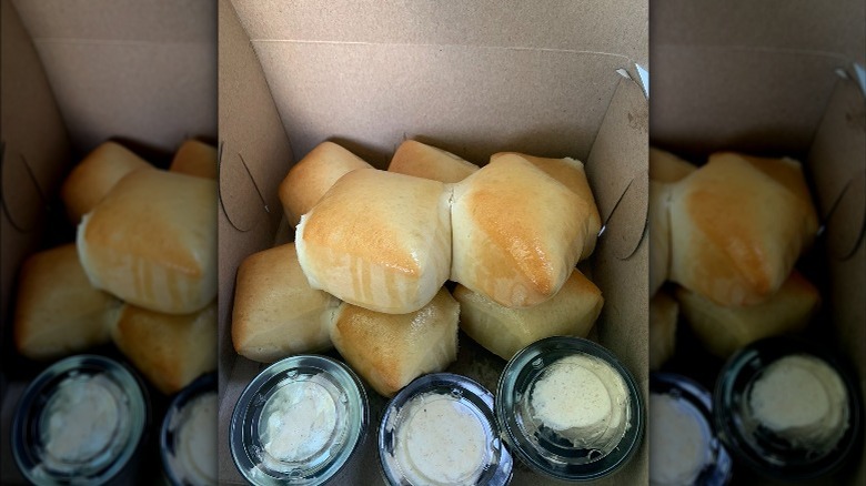 Texas Roadhouse rolls with cinnamon butter in to-go container