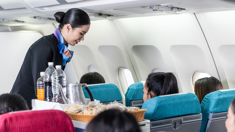 Flight attendant doing in-flight service