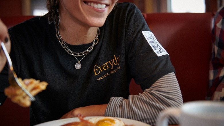 diner wearing Denny's Everyday Value tee