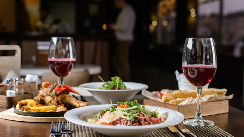 Multi-course dinner with glasses of wine