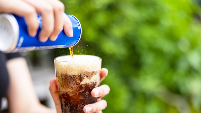 pouring soda into glass