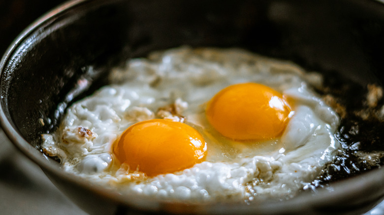 Close up of eggs frying in oil