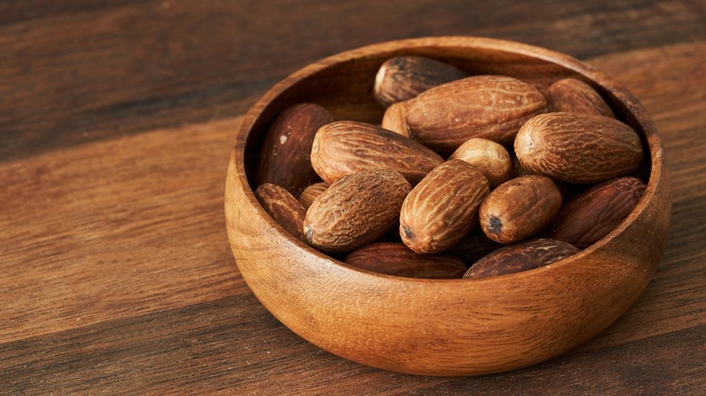 bowl of whole nutmeg kernels