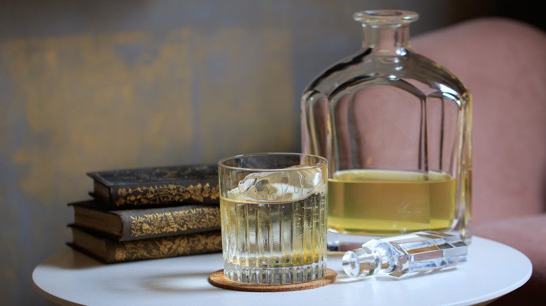 Clarified milk punch in glass and decanter