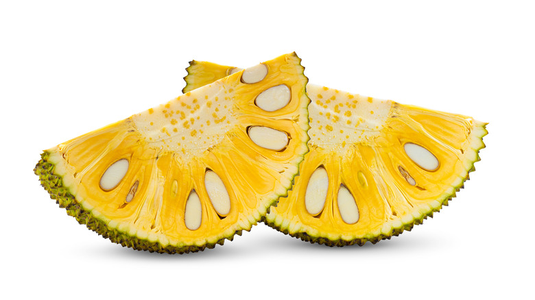 Jackfruit slices with seeds on white background