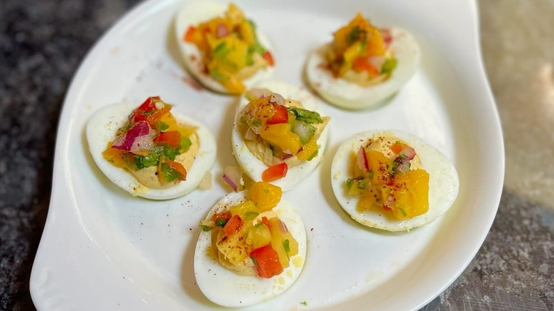 halved hard-boiled eggs with pico de gallo