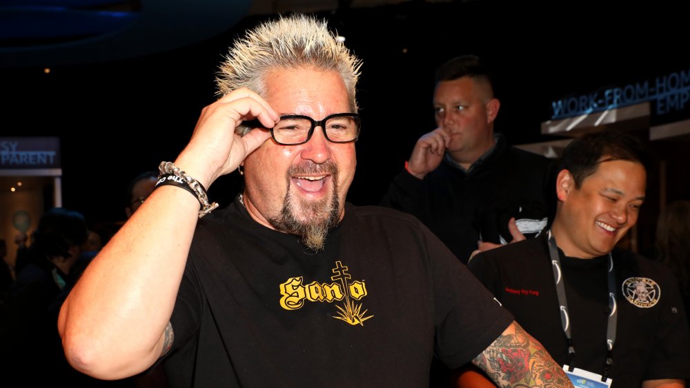 Guy Fieri smiling with coworkers