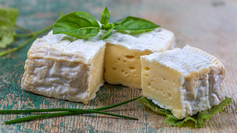 Pont L'Eveque cheese on wooden board 