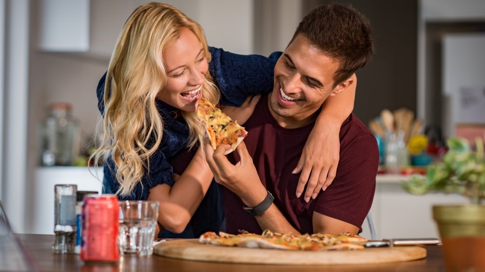 Couple eating pizza