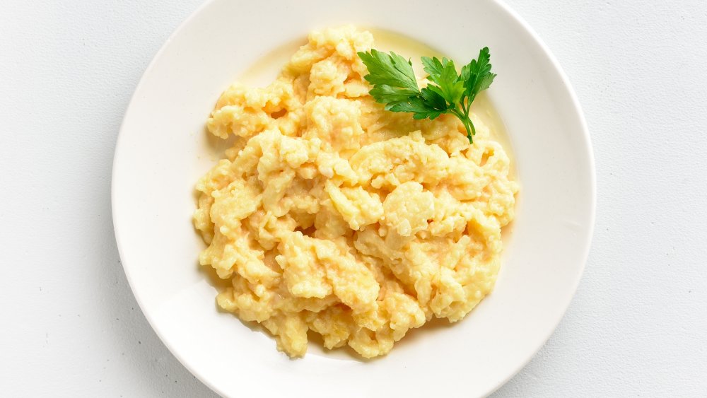 Scrambled egg in small cast-iron skillet. Making omelet eggs. Stock Photo  by ©boomeart 327353544