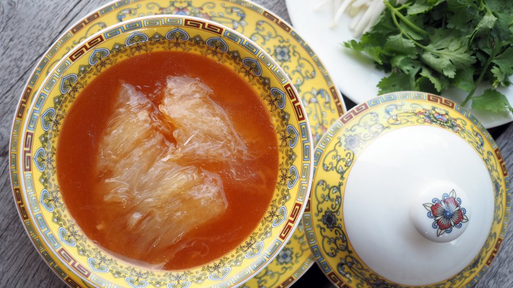 A bowl of shark fin soup with toppings