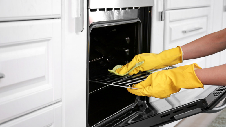 Person cleaning an oven