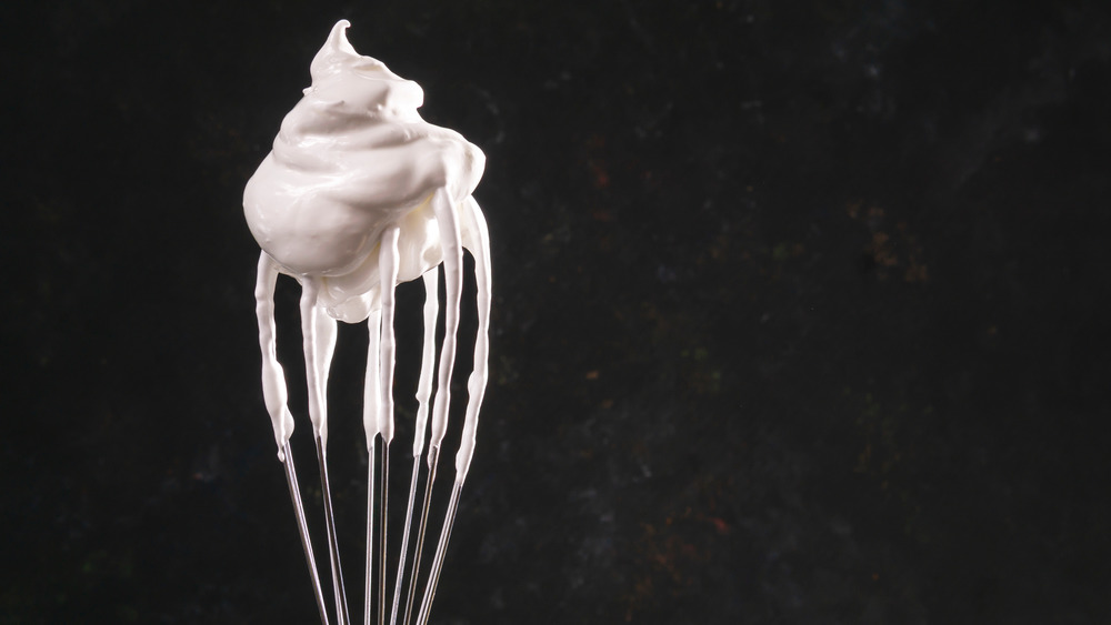 Dollop of whipped cream on top of a whisk