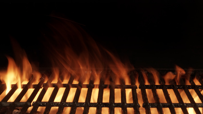 Flames shooting through an open grill