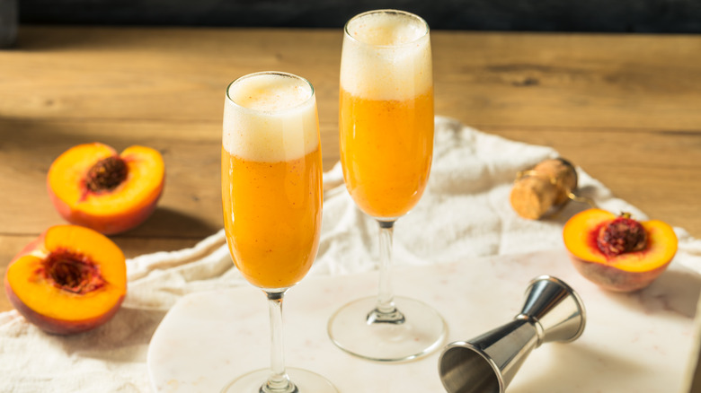 Bellinis and peaches on wooden table