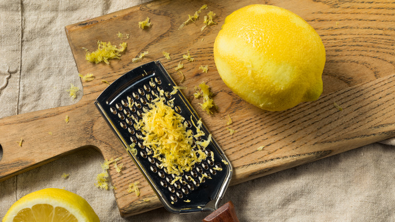 lemon and grated zest on cutting board