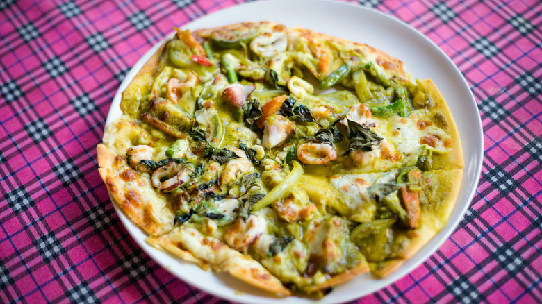 green curry pizza on a plate