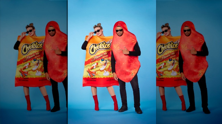 person hugging Flamin' Hot Cheetos bag