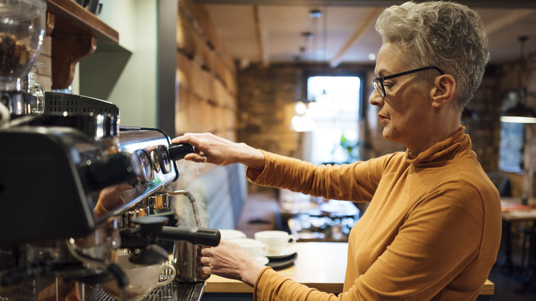 barista brewing on espresso machine