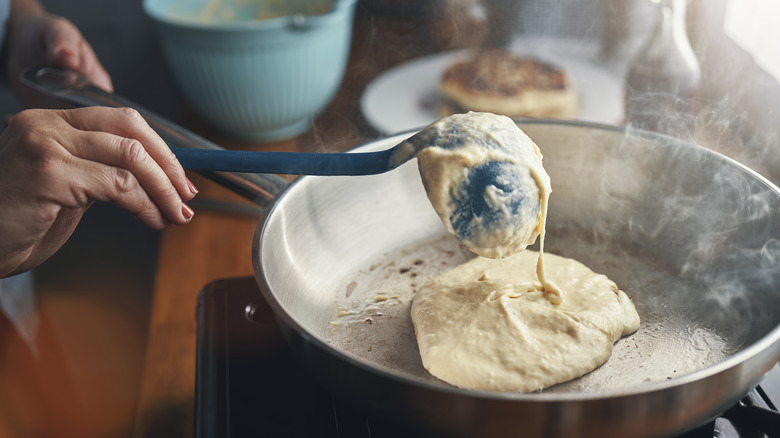 Person pouring batter in skillet