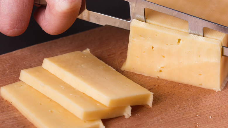 Cutting slices of cheese with a knife