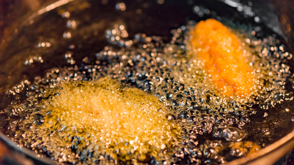 Chicken breasts frying in oil