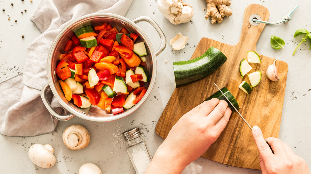 Chopping vegetables on wood cutting board